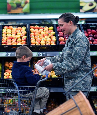 Woman in militray uniform with shopping cart